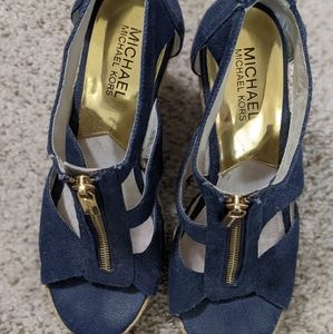 Navy blue Michael Kors wedges with gold interior and gold zipper. Size 7